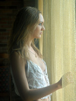 blonde in frilly white under cloths and soft lights.