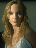 blonde in frilly white under cloths and soft lights.