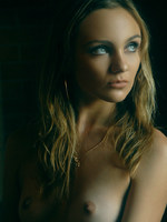 blonde in frilly white under cloths and soft lights.