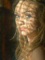 blonde in frilly white under cloths and soft lights.