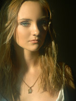 blonde in frilly white under cloths and soft lights.