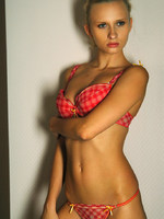 intense look on the face of this slim strong model as she poses for a soft photoset.