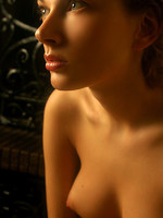 wet olya shares her large breasts and puffy nipples in this indoor shoot.